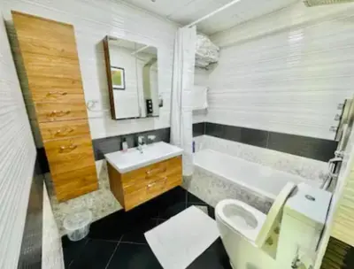 a bathroom with a sink and a tub and a toilet at Trendy Fully Equipped Beautiful Apartment for Four near to Metro in Dubai