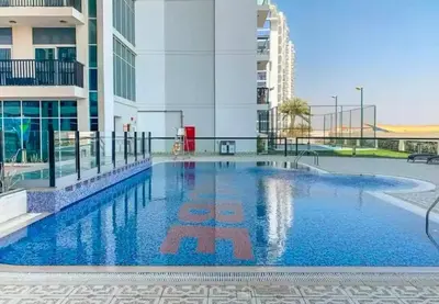 a swimming pool in the middle of a building at Trendy Fully Equipped Beautiful Apartment for Four near to Metro in Dubai