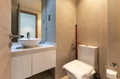 a bathroom with a white toilet and a sink at Cozy Marina Studio with Partial Sea View in Dubai