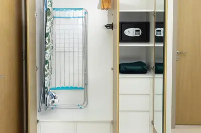 a walk in shower in a bathroom next to a door at Aykon Luxury Sky Collection Suites with Sea View by HSHOME in Dubai