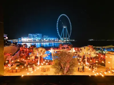 a large ferris wheel in a city at night at GuestReady - Enchanting retreat in JBR in Dubai