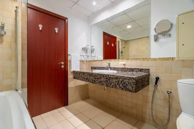 a bathroom with a sink and a toilet and a mirror at GuestReady - Enchanting retreat in JBR in Dubai