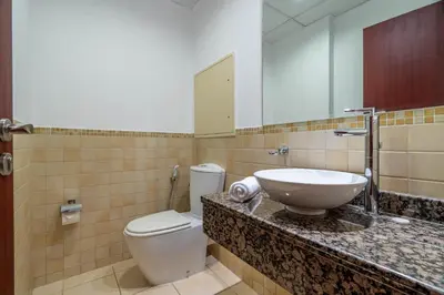a bathroom with a sink and a toilet and a mirror at GuestReady - Enchanting retreat in JBR in Dubai