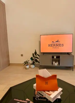 a flat screen tv in a living room with a table at 8min from Downtown in Dubai