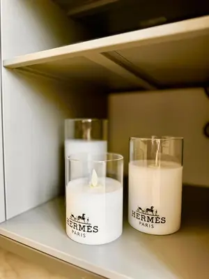 two candles are sitting on a shelf at 8min from Downtown in Dubai