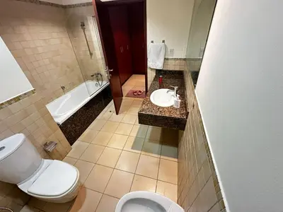 a bathroom with a toilet and a sink and a tub at HOT MASTER BED ROOM - JBR WALK Marina in Dubai