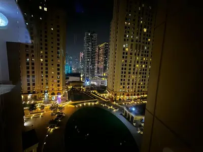 a view of a city at night with traffic at HOT MASTER BED ROOM - JBR WALK Marina in Dubai