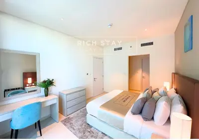 a bedroom with a bed and a desk and a sink at Seven Palm Escape 1BR in Palm Jumeirah in Dubai