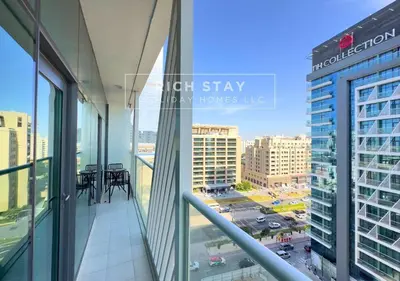 a balcony in a building with a view of a city at Seven Palm Escape 1BR in Palm Jumeirah in Dubai