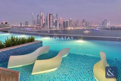 a view of a city skyline from a swimming pool at Seven Palm Escape 1BR in Palm Jumeirah in Dubai
