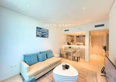 a living room with a couch and a table at Seven Palm Escape 1BR in Palm Jumeirah in Dubai