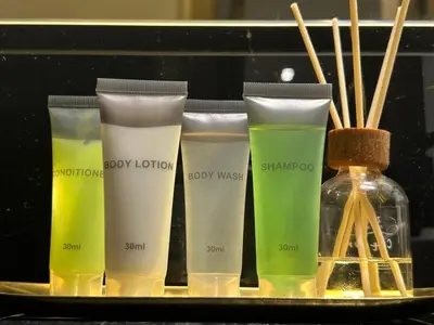 a tray with four different bottles of moisturizers on a shelf at Burj Khalifa Poolview 1BR Apartment for 4 people in Dubai