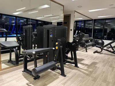 a gym with a bunch of treadmills and mirrors at Burj Khalifa Poolview 1BR Apartment for 4 people in Dubai