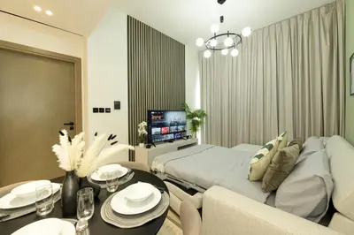 a living room with a couch and a bed and a table at Burj Khalifa Poolview 1BR Apartment for 4 people in Dubai
