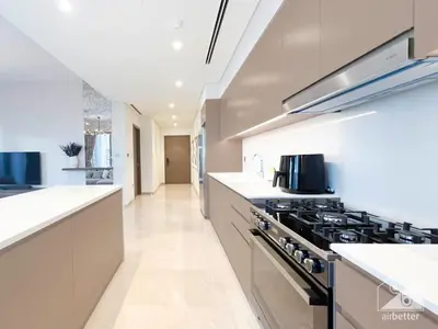 a kitchen with white counters and a stove top oven at Luxury Grande Downtown Full Burj khalifa Views in Dubai