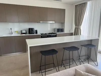 a kitchen with two bar stools and a counter top at Luxury Grande Downtown Full Burj khalifa Views in Dubai