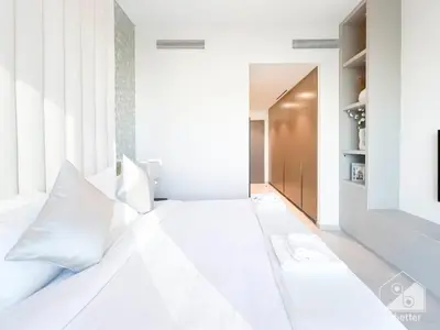 a white bed with white pillows in a bedroom at Luxury Grande Downtown Full Burj khalifa Views in Dubai