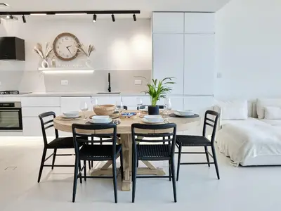 a kitchen and dining room with a table and chairs at Beachfront Townhouse SEA BREEZE in Dubai