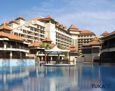 a resort with a large building in the background at Private Beach - 1-BHK - Palm Jumeirah - Resort in Dubai