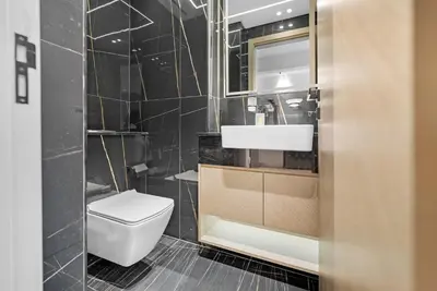 a bathroom with a toilet and a sink at Magnificent - New Modern 1BR in Binghatti Heights in Dubai