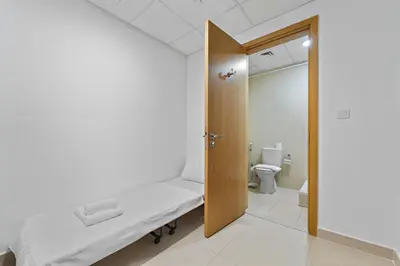 a hospital room with a bed and a toilet at 2BR plus Maid Bellevue Tower 1, Burj Khalifa View in Dubai