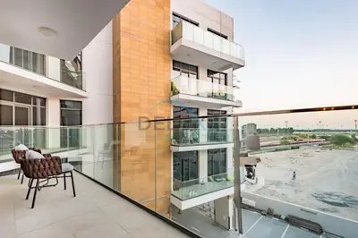 an apartment balcony with a view of a building at Contemporary 2BR in Azizi Park Avenue, Nad Al Sheba by Deluxe Holiday Homes in Dubai