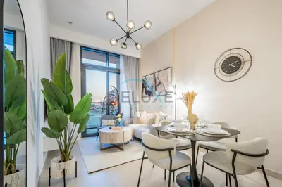 a living room with a table and chairs and a couch at Contemporary 2BR in Azizi Park Avenue, Nad Al Sheba by Deluxe Holiday Homes in Dubai
