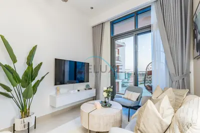 a living room with a couch and a tv at Contemporary 2BR in Azizi Park Avenue, Nad Al Sheba by Deluxe Holiday Homes in Dubai