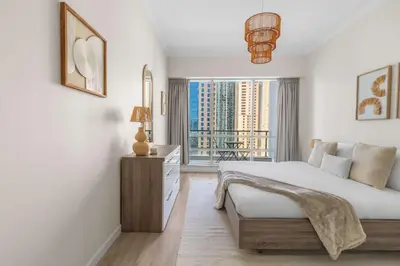 a bedroom with a bed and a large window at Superb Marina Views I Sleeps 5 in Dubai