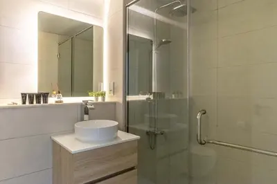 a bathroom with a sink and a glass shower at Superb Marina Views I Sleeps 5 in Dubai