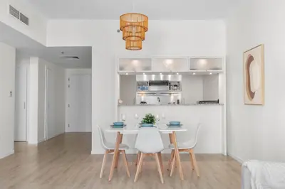 a kitchen and dining room with a table and chairs at Superb Marina Views I Sleeps 5 in Dubai