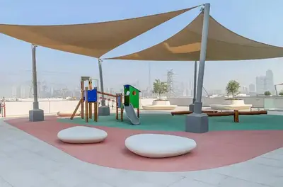 a playground under a tent with a swing at District one Full Water view Apartment in Dubai