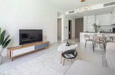 a living room with a large television and a table at District one Full Water view Apartment in Dubai