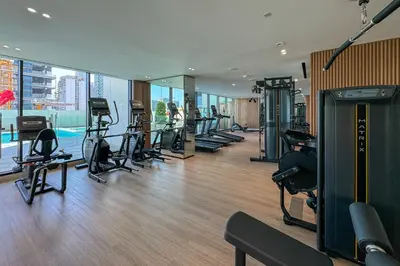 a gym with a bunch of treadmills and exercise equipment at Stylish 1 Bedroom in Binghatti Lavender JVC in Dubai