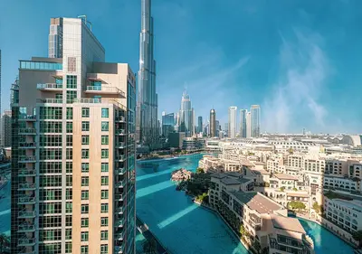 a view of a city with a river and buildings at Stunning 2 BR Burj Khalifa Fountain Views in Dubai