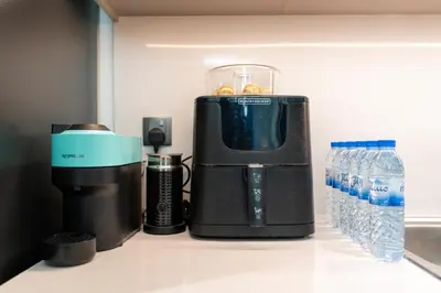 a coffee maker on a counter next to water bottles at Westminster ACT1 ACT2 Burj Khalifa in Dubai