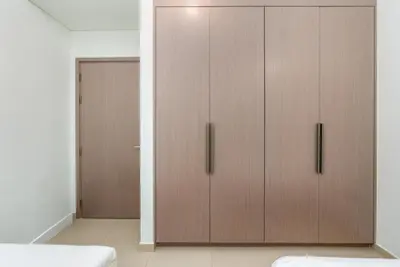 two wooden cabinets in a room with a door at Westminster ACT1 ACT2 Burj Khalifa in Dubai