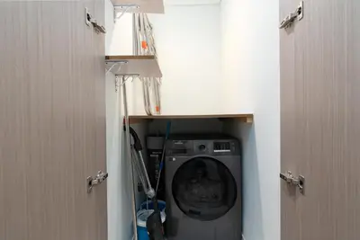 a washer and dryer in a bathroom with two doors at Westminster ACT1 ACT2 Burj Khalifa in Dubai