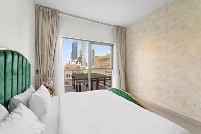 a bedroom with a bed and a view of the city at 2BR plus Maid Bellevue Tower 1, Burj Khalifa View in Dubai