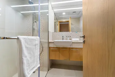 a bathroom with a sink and a mirror at 2BR plus Maid Bellevue Tower 1, Burj Khalifa View in Dubai