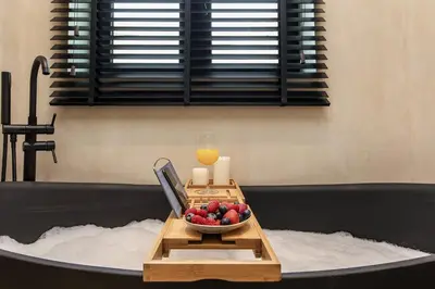a table with a bowl of fruit and a candle at Heart of Dubai in Dubai