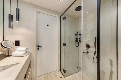 a bathroom with a shower with a glass door at Heart of Dubai in Dubai