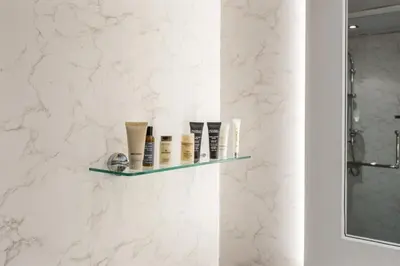 a bathroom with a shelf with cosmetics on it at Burj View Luxury 1BR - Full Sea View Private Beach - Anantara Palm in Dubai