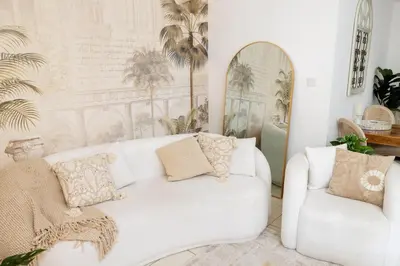 a living room with a white couch and two chairs at 1001 Nights - Luxury 1-BR apartment near Burj in Dubai
