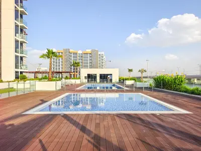a swimming pool on the deck of a building at Tranquil Studio Getaway in Meydan City in Dubai