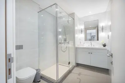 a bathroom with a shower and a toilet and a sink at Luxury Apartment in the Heart of Downtown Dubai in Dubai