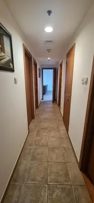 a hallway of a room with a tile floor at Private Rooms in CoLiving Apartments UP Tower DIFC in Dubai