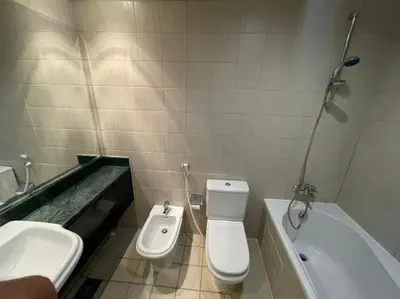 a bathroom with a toilet and a sink and a tub at Private Rooms in CoLiving Apartments UP Tower DIFC in Dubai