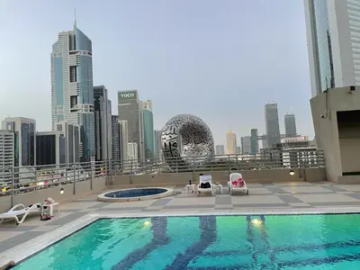a swimming pool on the roof of a building at Private Rooms in CoLiving Apartments UP Tower DIFC in Dubai