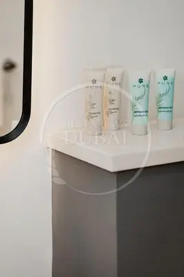 a shelf with four cups on top of a sink at Luxury 2Bdr Apartment in Business Bay in Dubai
